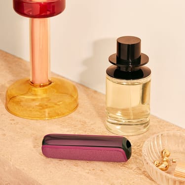 ploom-aura-dark-orchid-device-placed-table