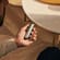 Hand holding Ploom AURA front panel Lunar Silver Augmented Pattern accessory on device.