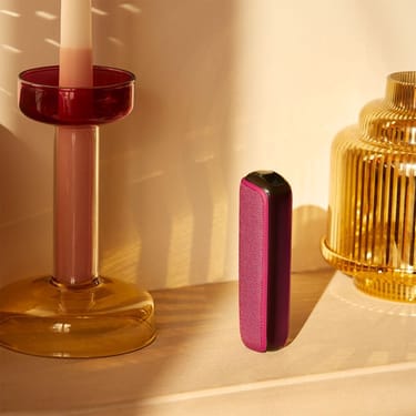 ploom-aura-dark-orchid-device-standing-table