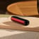 Ploom AURA front panel Lava Red accessory attached to device on a table.