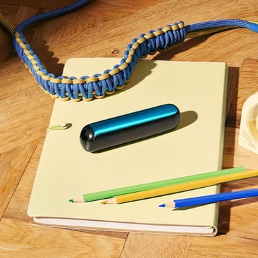 Ploom AURA front panel Ocean Blue accessory attached to device on a desk.