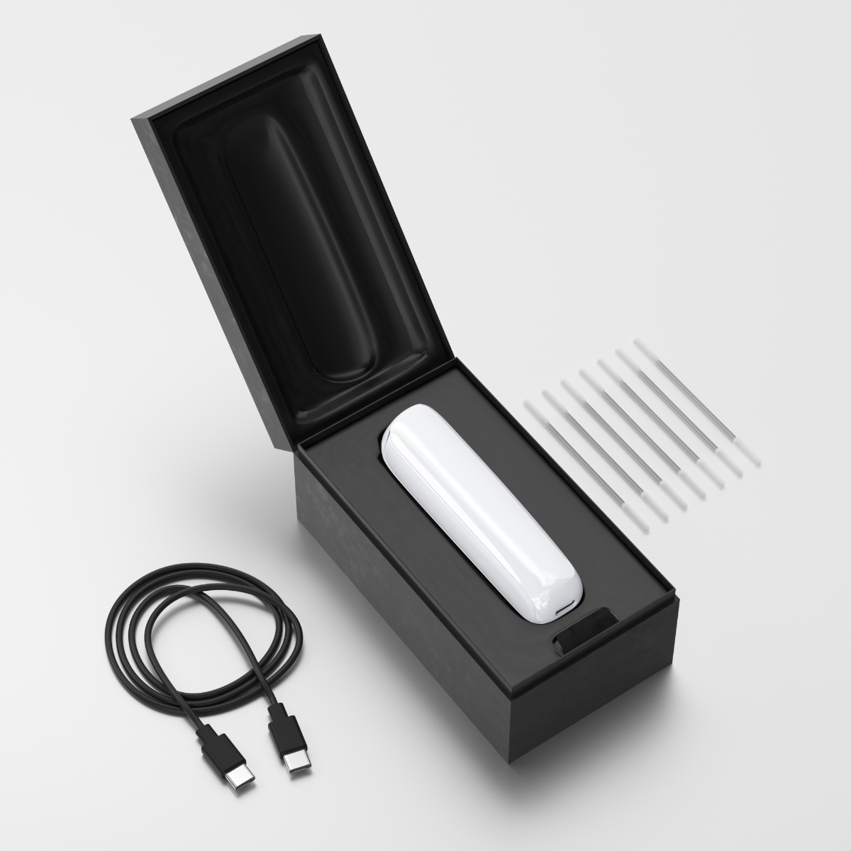 Scatola aperta del Ploom AURA che mostra il dispositivo, il cavo di ricarica e gli stick per la pulizia.